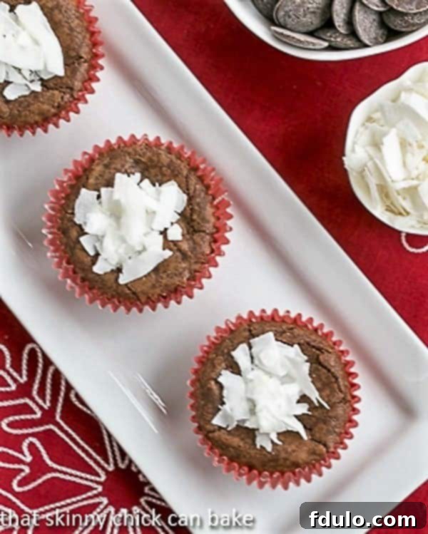 A close-up shot of several Mounds brownie cupcakes arranged neatly on a white tray, highlighting their rich chocolate exterior and promise of a coconut center.