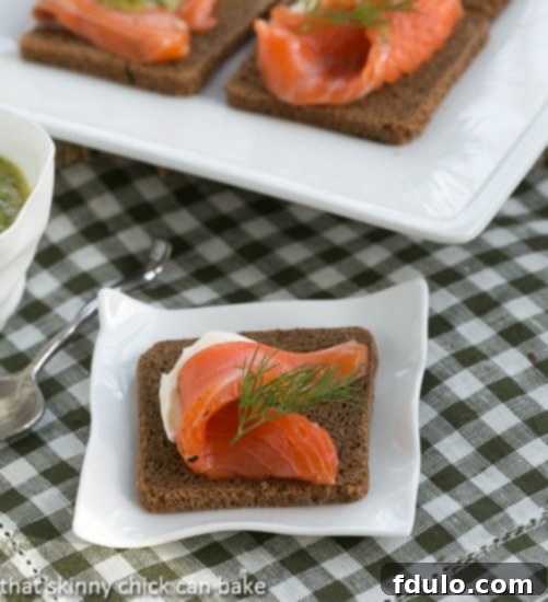 Exquisite Dilled Gravlax slices artfully arranged on a serving platter, glistening with freshness.