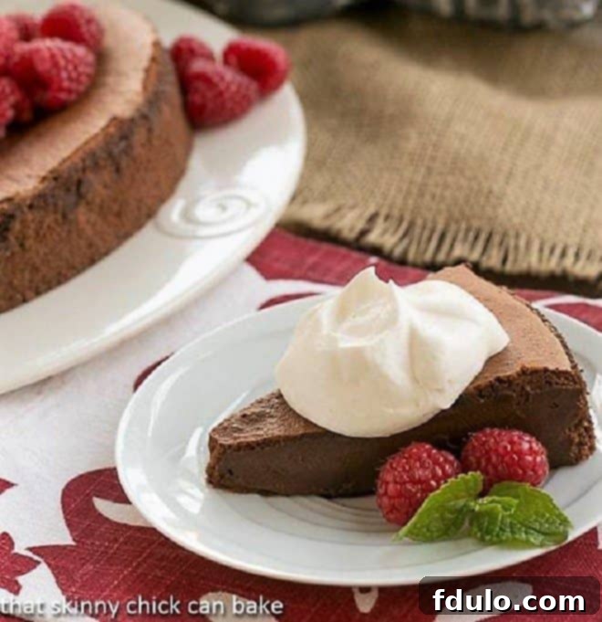 Chocolate Mousse Torte topped with delicate swirls of whipped cream, ready to be served