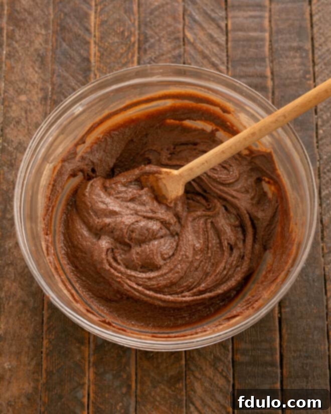 Step 6: Gradually adding dry ingredients to the wet mixture.