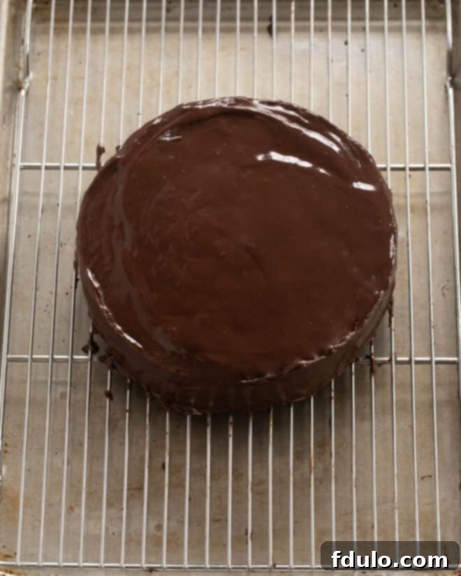 Step 11: Applying ganache to the cooled cake.