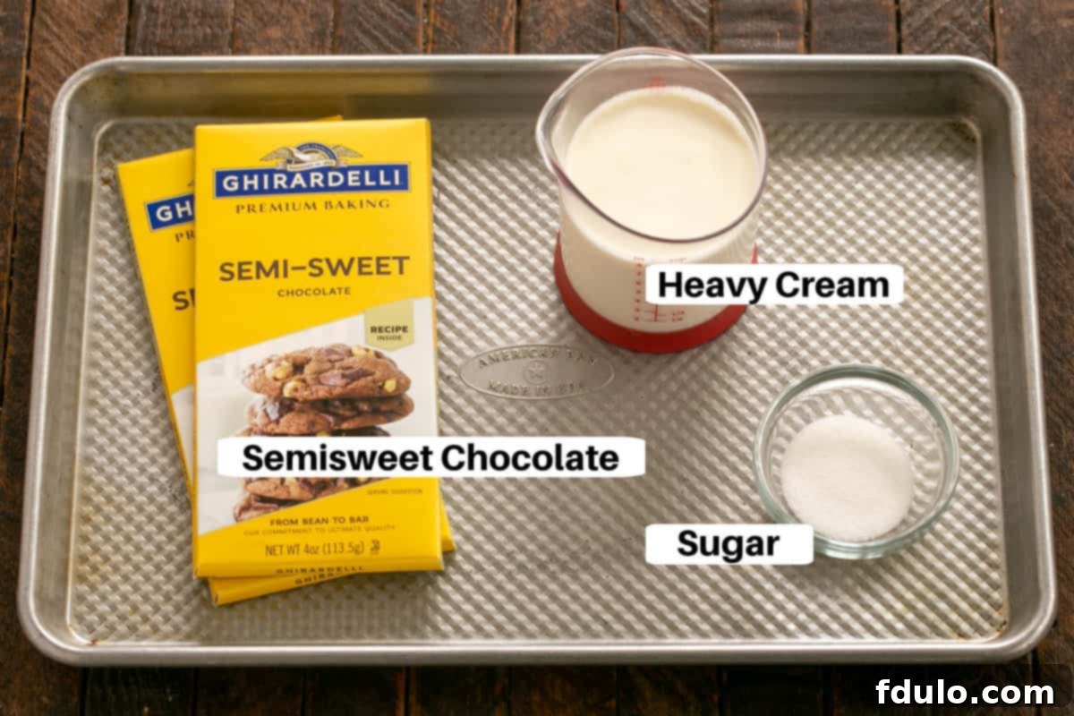 All the necessary ingredients for crafting the perfect chocolate ganache, neatly displayed on a metal sheet pan.