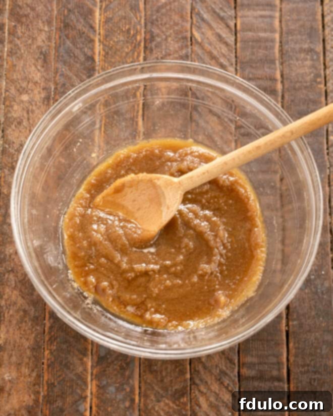 Step 3: Mixing melted butter and brown sugar in a separate bowl.