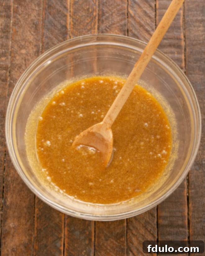 Step 4: Adding eggs and vanilla extract to the butter mixture.