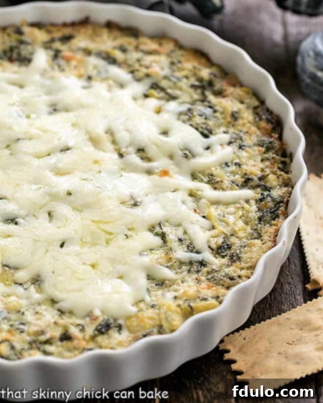 Spinach and Artichoke Dip in a casserole dish, ready to be served.