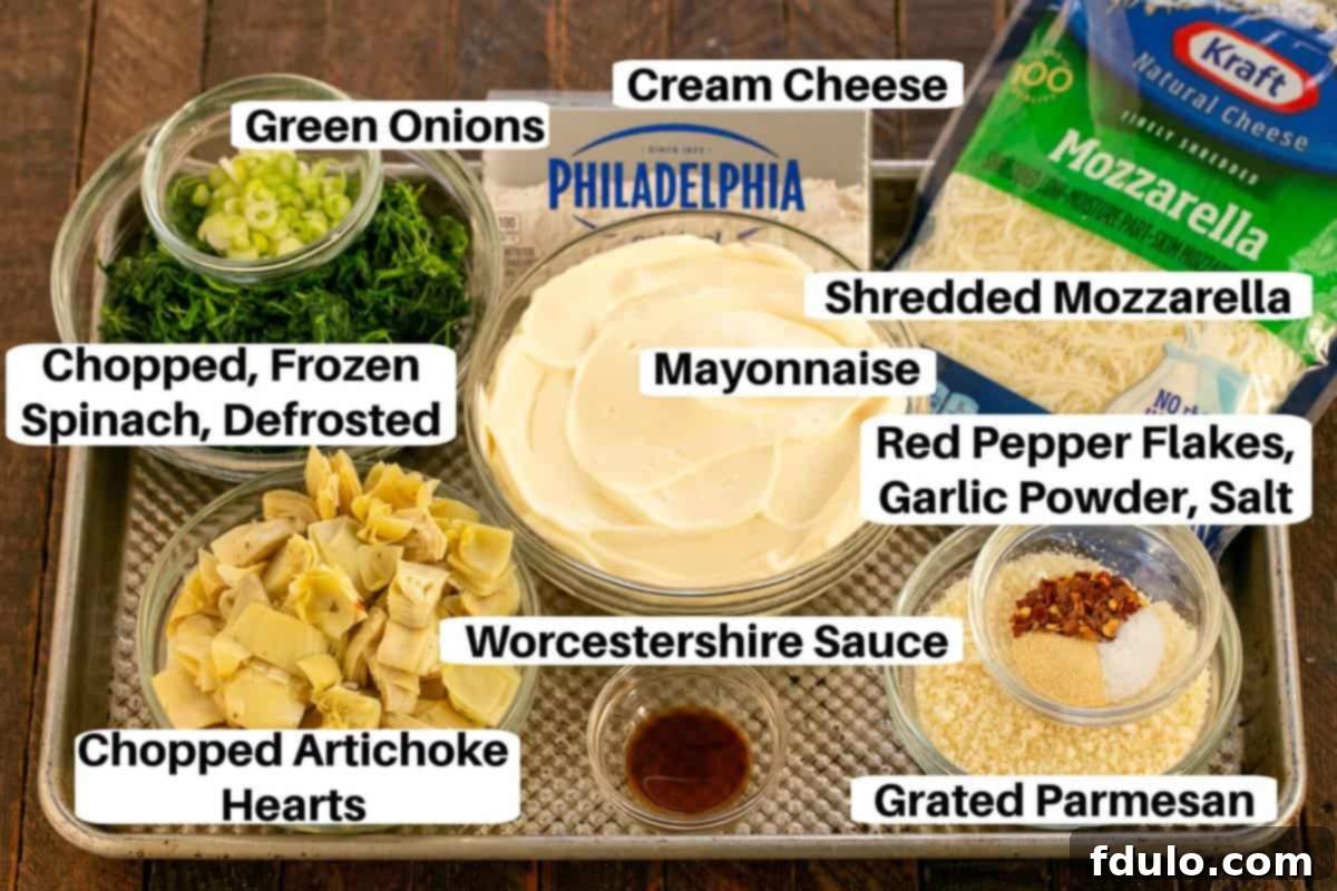 Spinach Artichoke Dip Ingredients laid out on a sheet pan with labels, ready for mixing.
