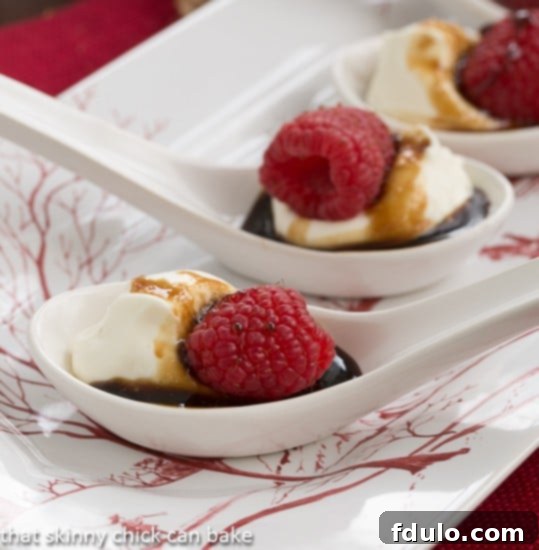 Closeup view of Balsamic Raspberries with Mascarpone Cream in white Chinese soup spoons