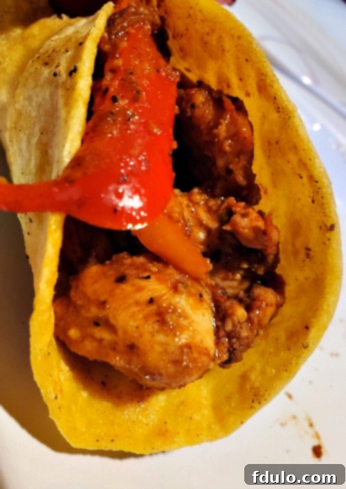 A vibrant plate of steak fajitas with grilled peppers, onions, and fresh lime wedges, ready to be enjoyed.