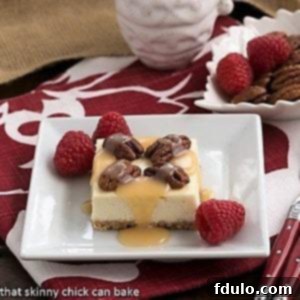 A slice of caramel pecan cheesecake bars, showcasing the layers and toppings.