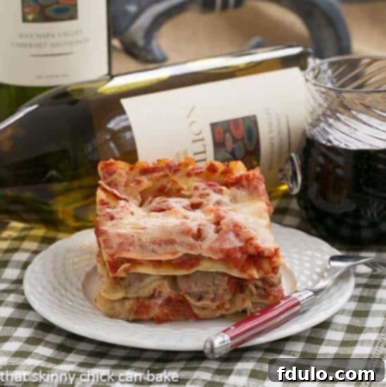 A perfectly portioned slice of Easy Sausage and Mushroom Lasagna, showcasing distinct layers of pasta, rich sauce, savory sausage, tender mushrooms, and melted cheese, served on a pristine white plate.