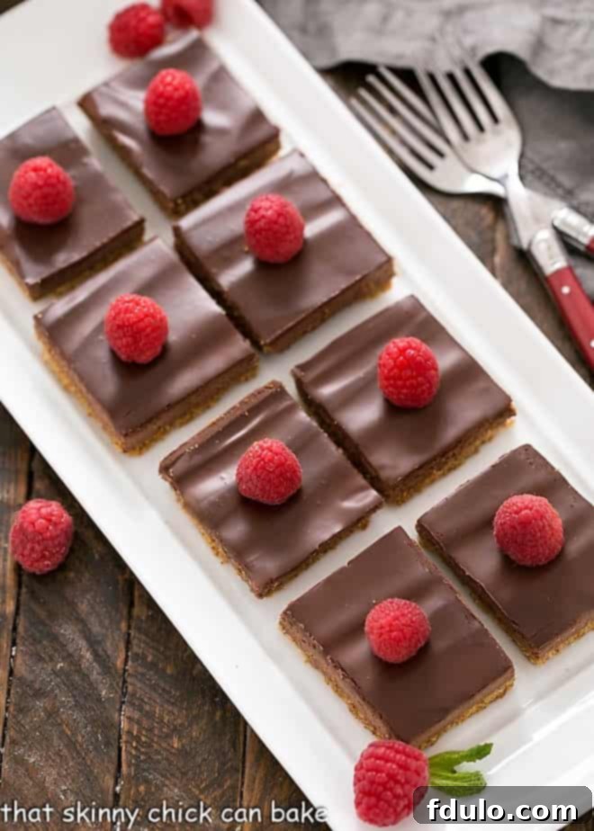 An overhead shot of several Dark Chocolate Mousse Bars arranged neatly on a white serving tray, highlighting their elegant presentation and tempting layers.