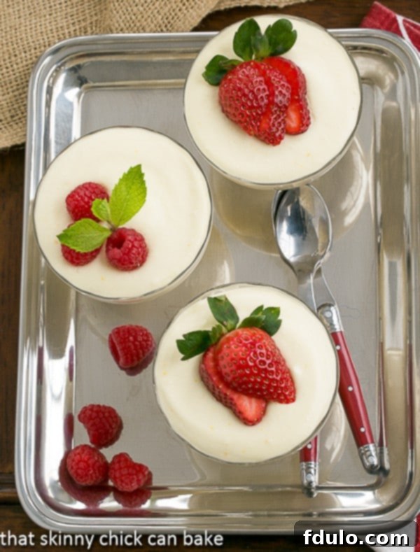 Dreamy White Chocolate Mousse Recipe spiked with Frangelico served in elegant glass parfait dishes on a silver tray, ready for a sophisticated dessert experience.