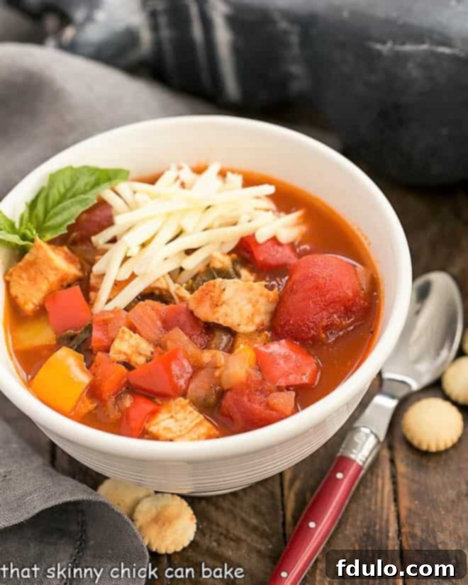 Flavorful Chicken and Bell Pepper Chili - A unique, pepper-packed chicken chili recipe that's always a hit for game day, family dinners, or any comforting meal occasion. A steaming bowl of Chicken and Bell Pepper Chili, garnished with fresh herbs, ready to be served.