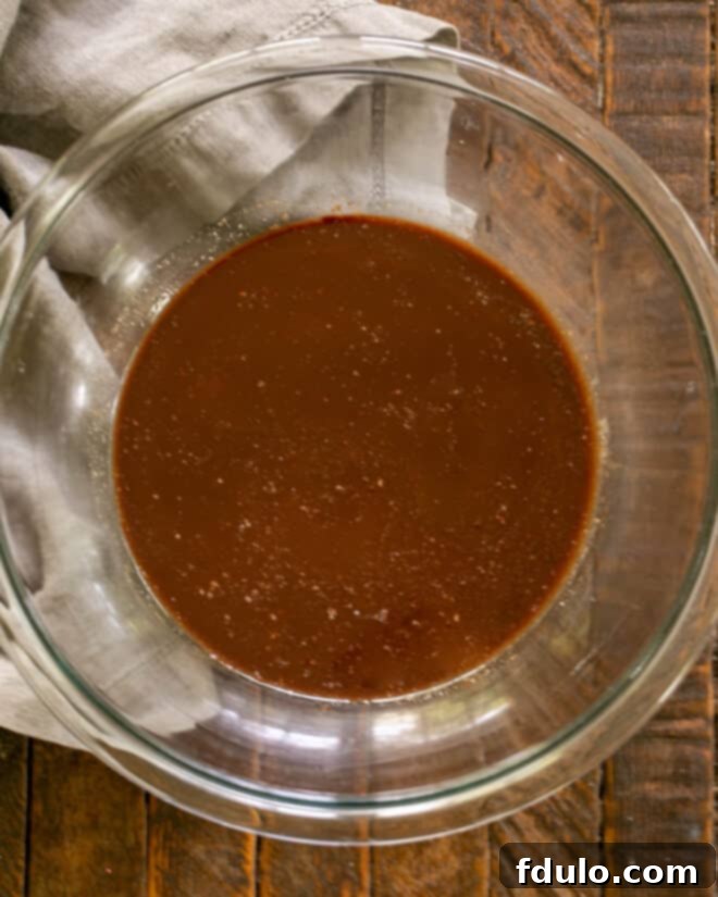 Melting chocolate and butter together in a microwave-safe bowl.