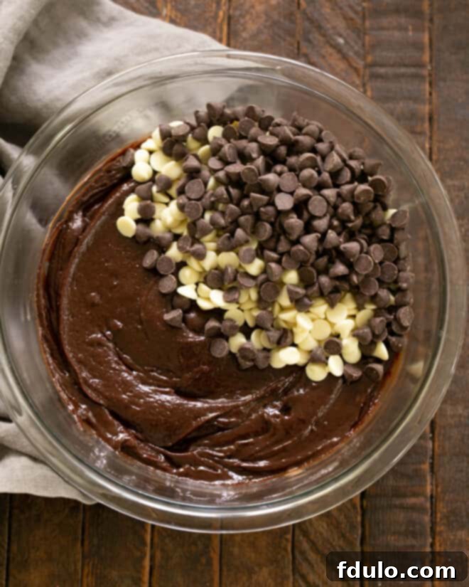 Folding in chocolate chips into the brownie cookie dough.