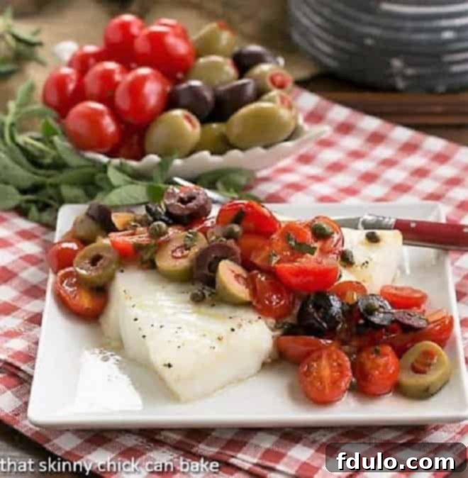 Sea Bass with Tomatoes, Olives and Capers on small square plate with fork.