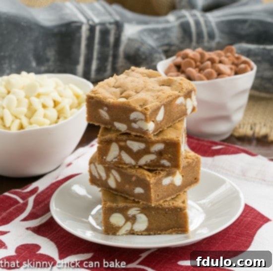 Close-up of a stack of Butterscotch Blondies with White Chocolate Chips, showing their moist texture.