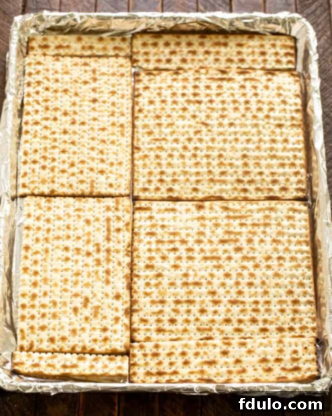 Layer Matzo on a rimmed sheet pan lined with foil and parchment paper.