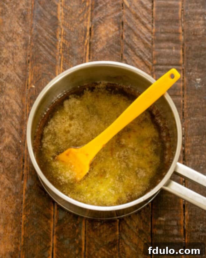 Boil butter and brown sugar together in a saucepan for 3 minutes to create the caramel base.