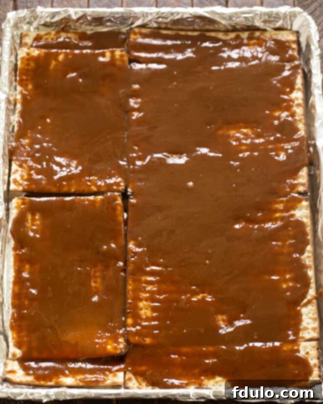 Pour the hot caramel mixture evenly over the matzo sheets.