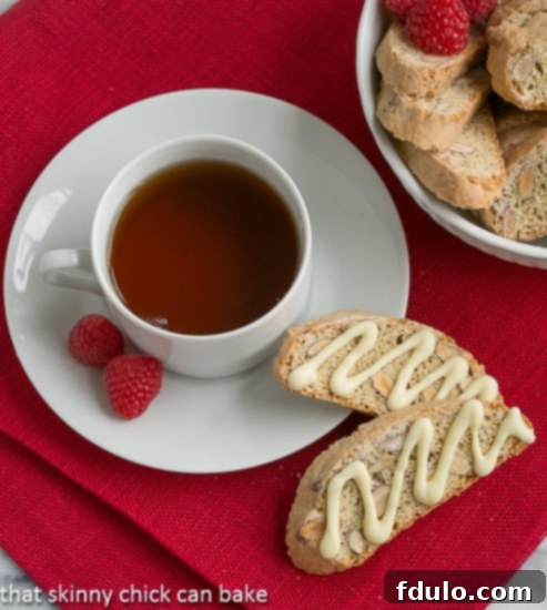 Overhead view of two Cantuciini or Almond Biscotti next to a cup of tea
