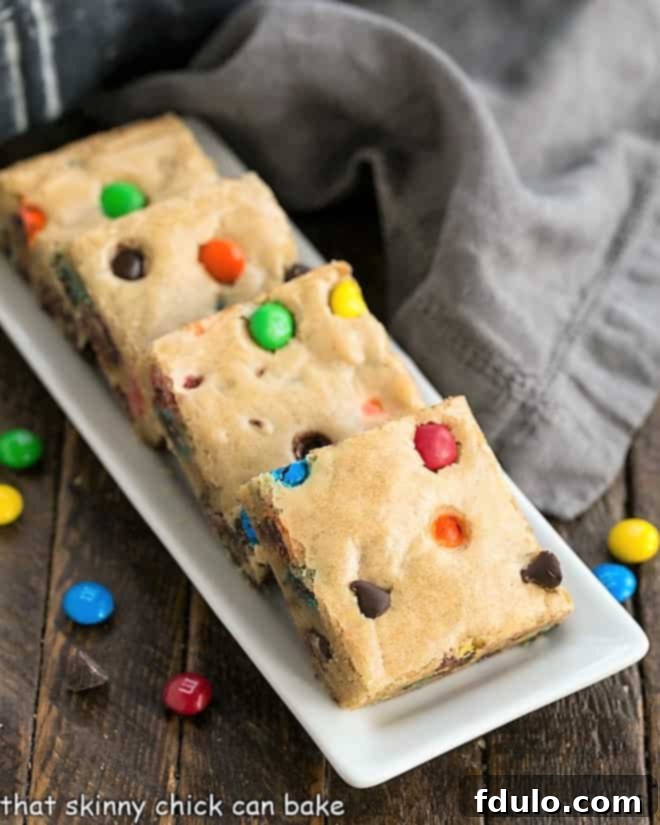 M & M Blondies on a narrow white tray.