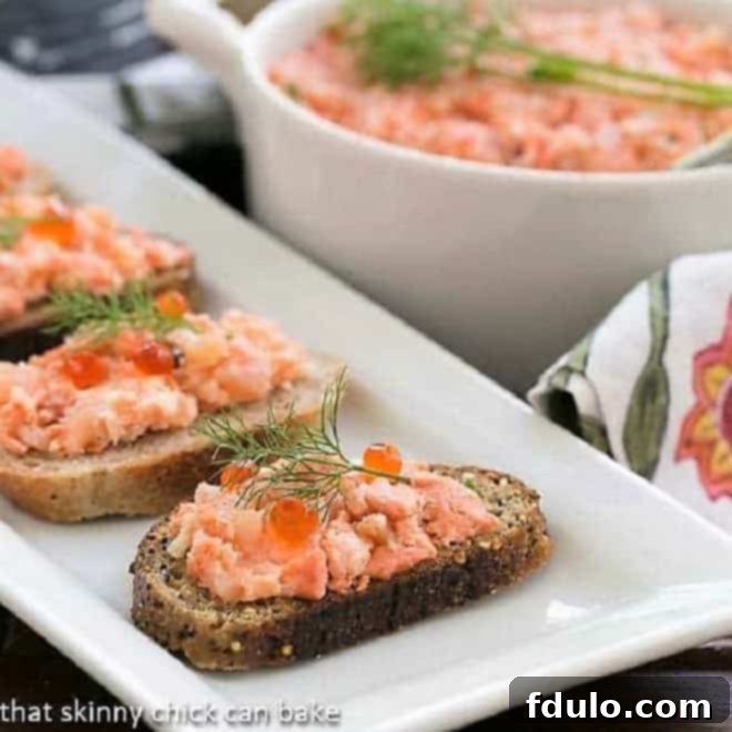 Salmon Rillettes, a creamy French seafood spread, served elegantly on small toasts on a white platter, garnished for a sophisticated appetizer.