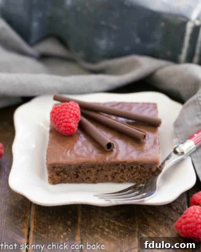 Chocolate Syrup Brownies on a square white plate with a fork.