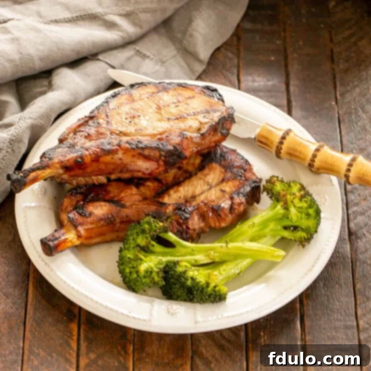 Marinated pork chops with broccoli on a dinner plate.