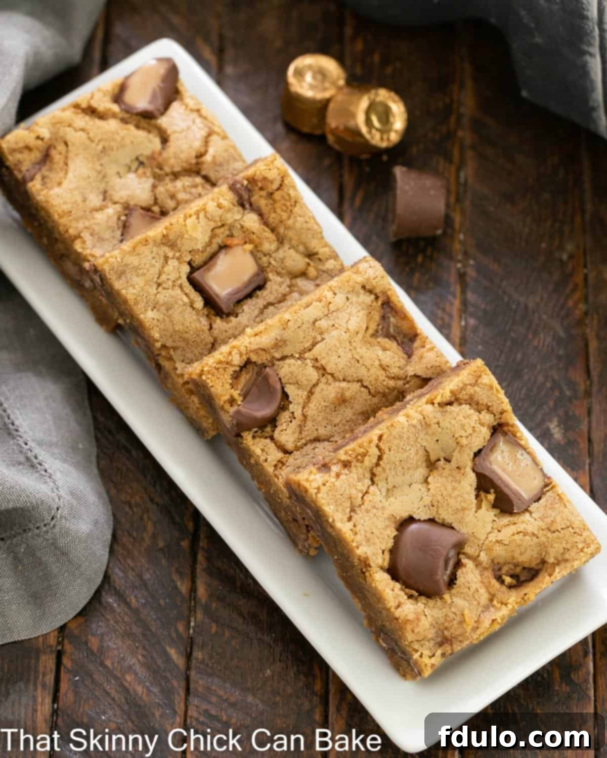 Golden Biscoff Bars: Freshly Baked and Delicious An overhead view of a baking tray filled with freshly baked Biscoff squares, perfectly golden and ready to be enjoyed.