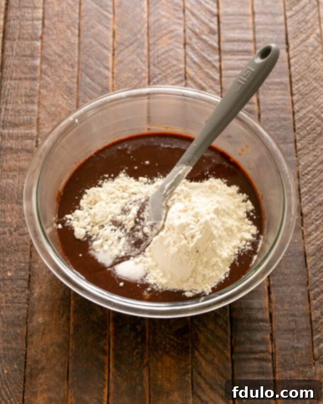 Flour and salt being added to the brownie batter.