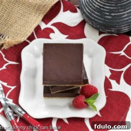 Overhead view of a stack of Truffle Brownies on a white square plate, emphasizing their rich texture.
