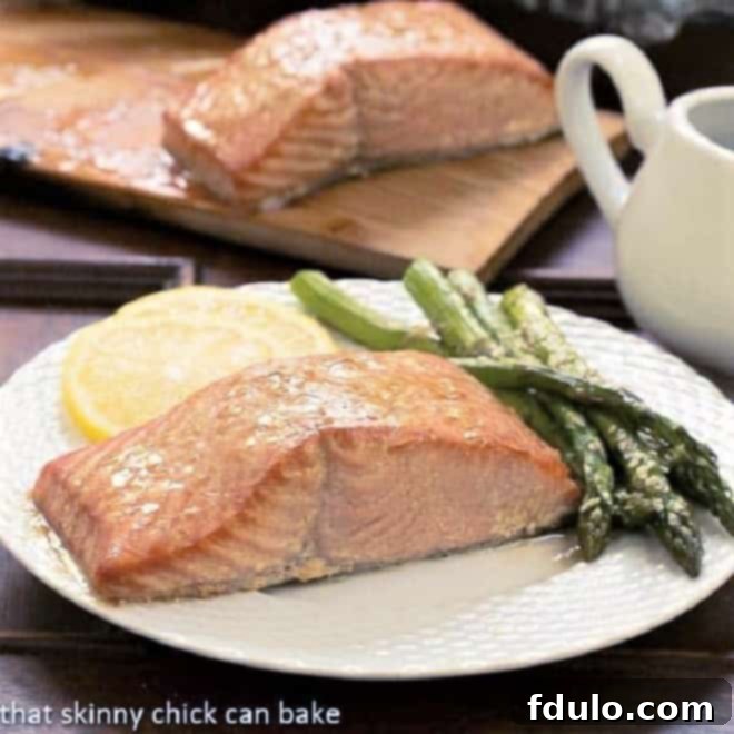 Achieve an elegant and delicious seafood entree with this easy Grilled Cedar Plank Salmon recipe, featuring a simple yet flavorful marinade. Grilled Cedar Plank Salmon on a white plate with asparagus, perfectly cooked and ready to serve.