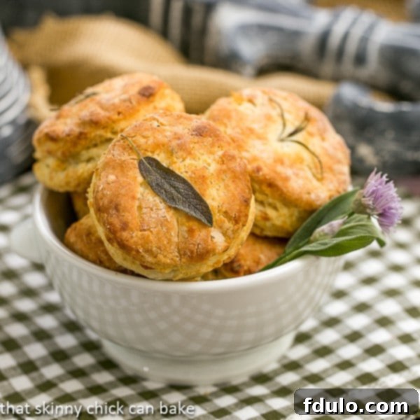 Warm Herbed Buttermilk Biscuits in a rustic bowl, garnished with fresh herbs, ready to serve.
