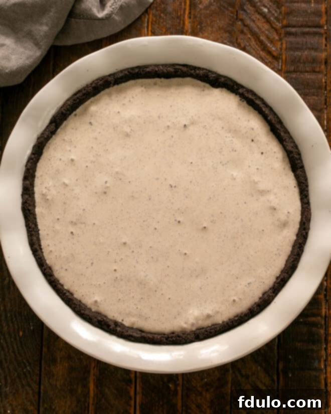 Step 3: Spread the Kahlua and brandy-infused ice cream evenly into the frozen cookie crust.