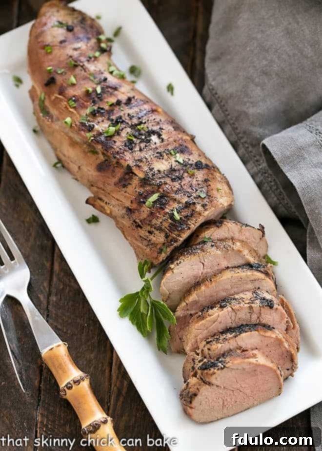 Grilled pork tenderloin on a rectangular white platter