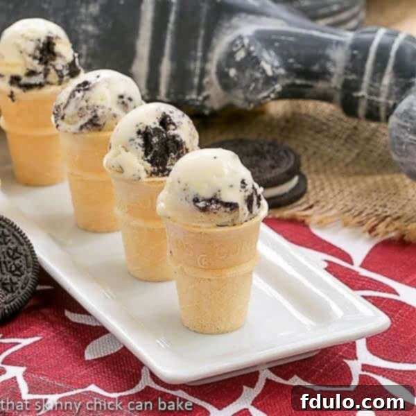 Four mini cones filled with creamy Oreo Ice Cream, arranged on a white serving tray.