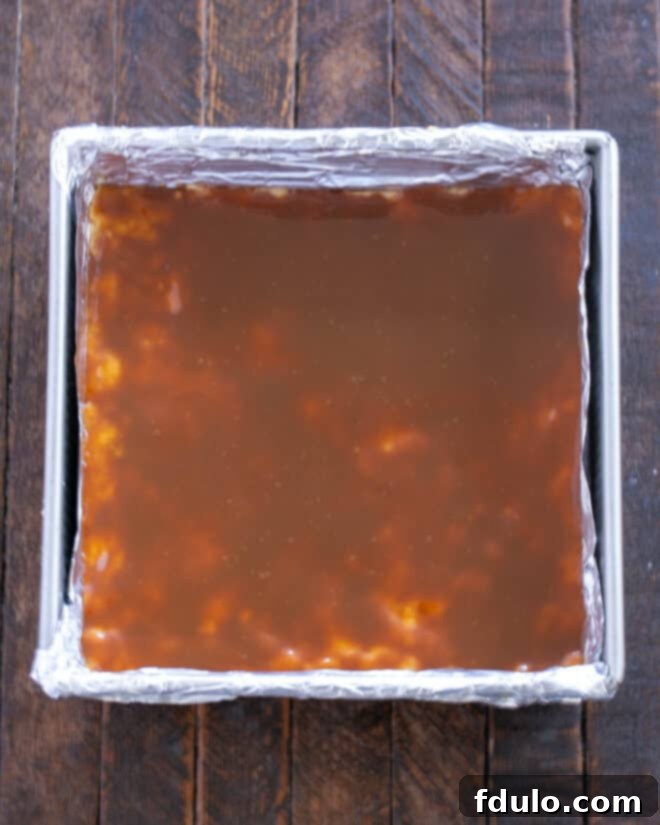 Golden Caramel Squares 9 Caramel sauce is carefully spread over the warm shortbread crust with an offset spatula.