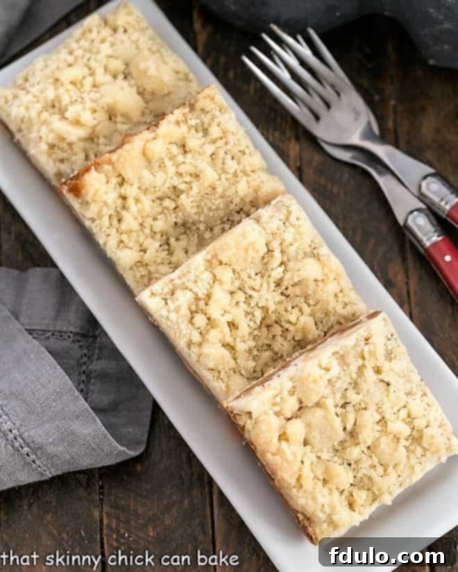 Caramel Butter Bars - Simple flavors with delicious results! An overhead view of a tray filled with freshly baked Caramel Butter Bars, showing their golden brown streusel topping and gooey caramel peeking through.