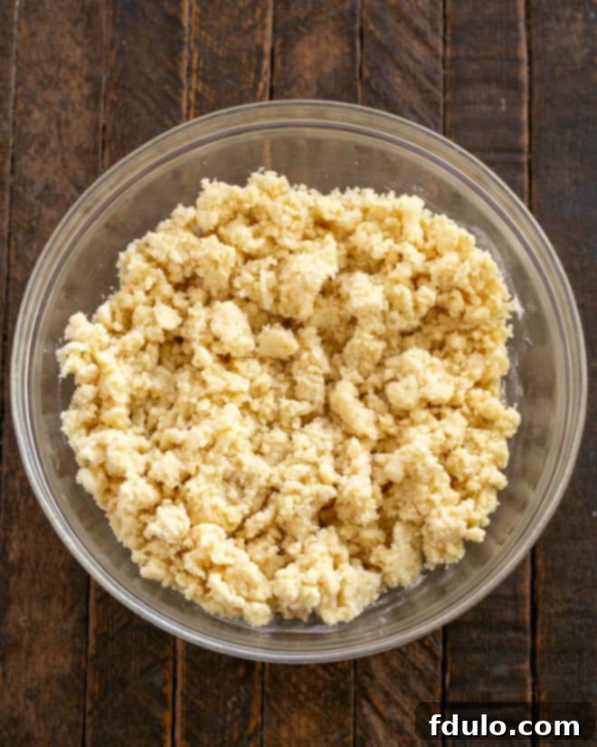 Golden Caramel Squares 6 Flour is added to the creamed butter and sugar mixture, and a portion of the dough is pressed into a baking pan.