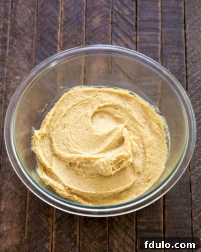 Ultimate Oreo Chocolate Chip Bars 4 Step 2: Mixing in eggs and vanilla extract.