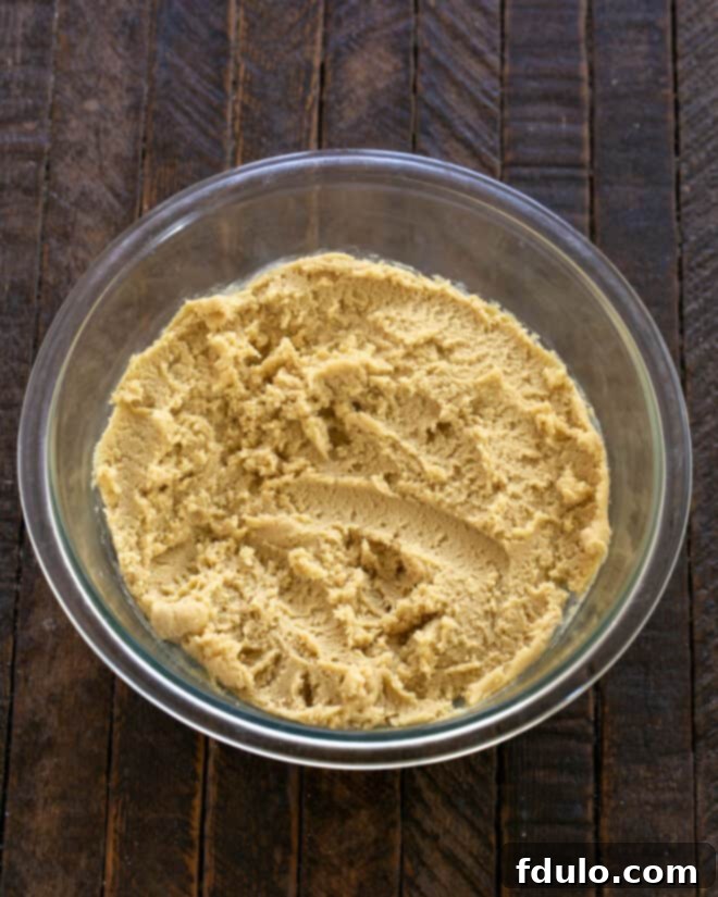 Ultimate Oreo Chocolate Chip Bars 6 Step 4: Adding dry ingredients: flour, baking soda, baking powder, and salt.