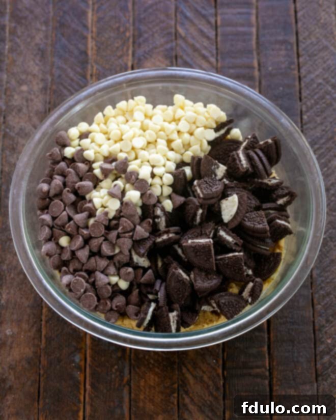 Ultimate Oreo Chocolate Chip Bars 7 Step 5: Folding in chocolate chips and chopped Oreo cookies.