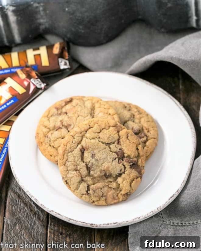 A selection of chewy Brown Butter Toffee Cookies arranged on a round white plate, ready to be enjoyed.