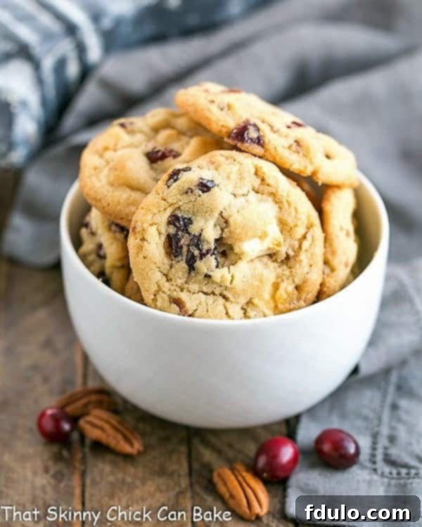 Cranberry, White Chocolate, Crystallized Ginger Cookies beautifully arranged in a white bowl, showcasing their inviting appearance.