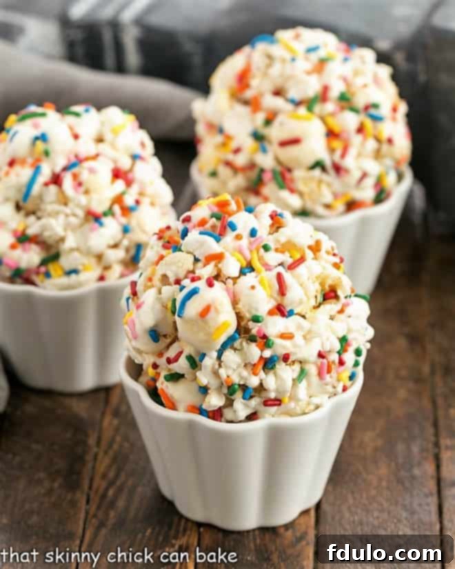 Three golden marshmallow popcorn balls nestled in elegant scalloped white ramekins, ready to be enjoyed.