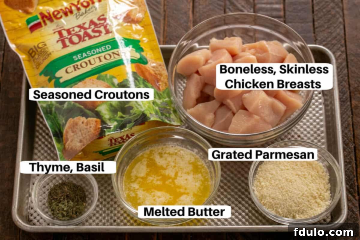 The Ultimate Homemade Chicken Nuggets 2 Homemade Chicken Nuggets Ingredients on a metal sheetpan with labels including butter, thyme, basil, Parmesan, croutons, and chicken.