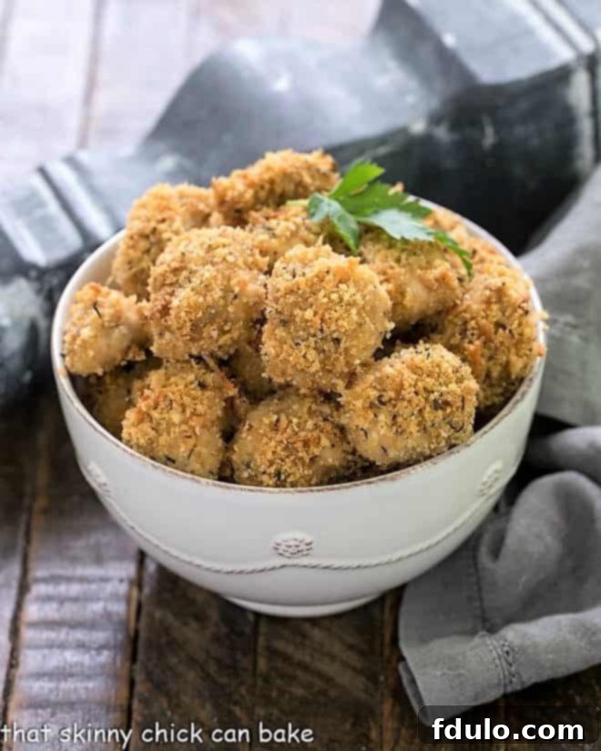 The Ultimate Homemade Chicken Nuggets 8 Step-by-step image of herbed chicken nuggets served warm in a white bowl.