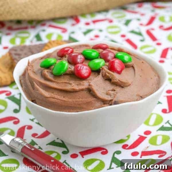 Decadent Brownie Batter Dip in a white bowl topped with colorful M&M's, ready to be served as a delightful treat or appetizer.