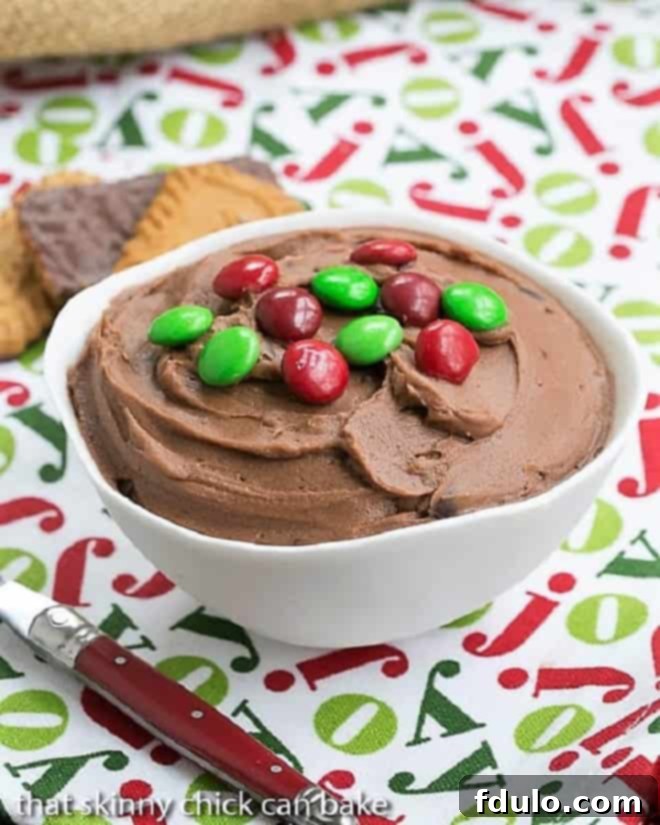 Brownie Batter Dip in a white serving bowl topped with M & M's